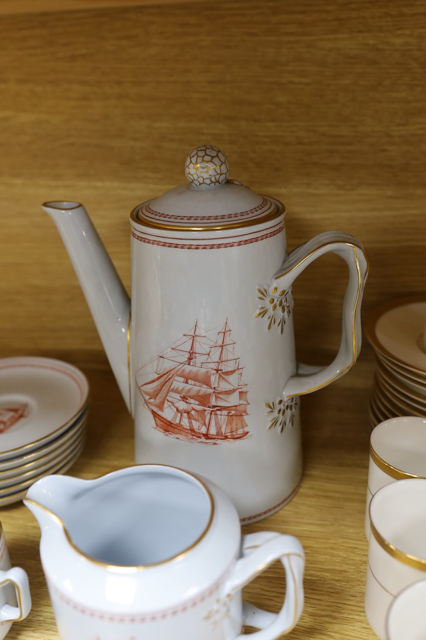 A Copeland fifteen piece coffee service, Trade Winds pattern, and a Doulton Royal Gold pattern coffee set